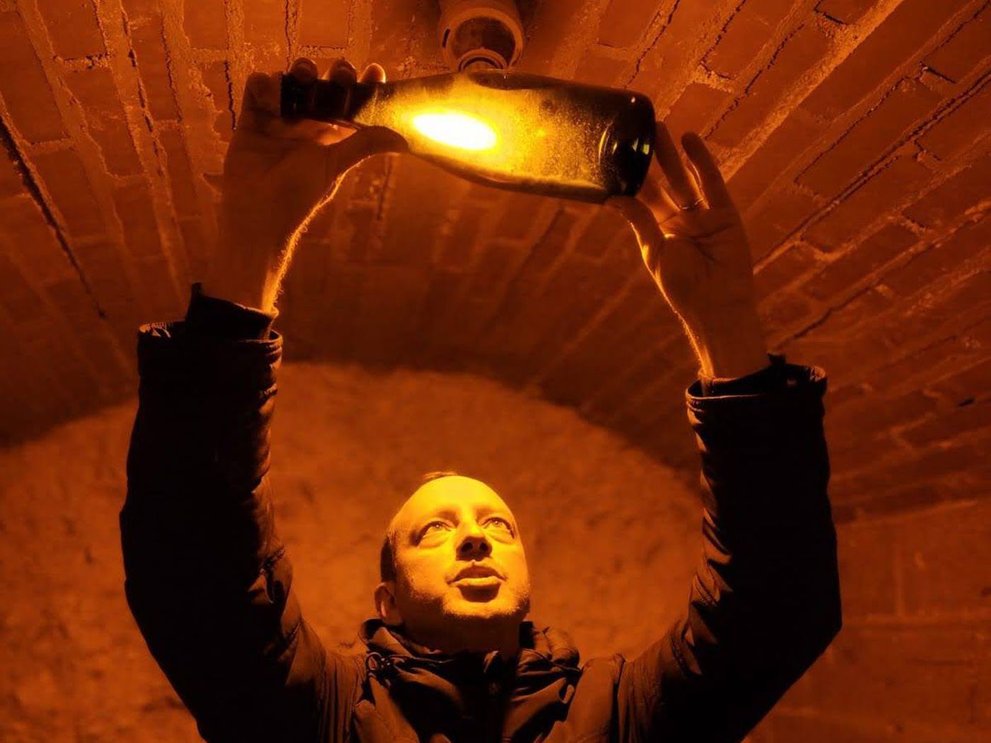 Guide showing botlle of champagne in cellar