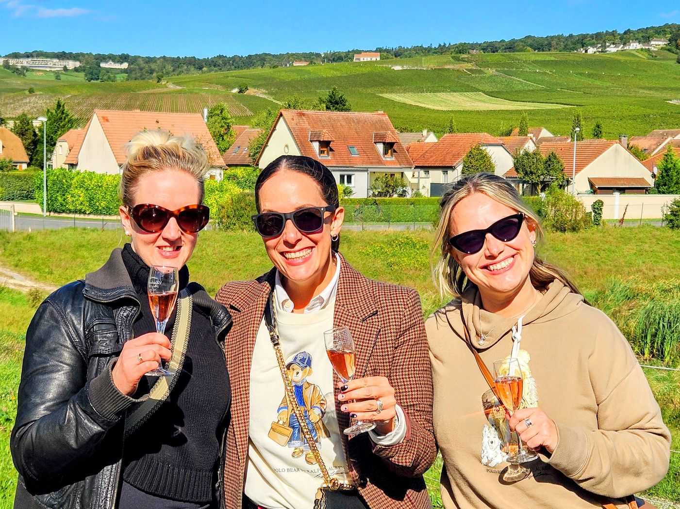 Tourists tasting champagne in a sunny vineyard